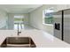 Kitchen island sink with stainless steel refrigerator and view of the backyard at 4210 Sea Marsh Pl, Parrish, FL 34219