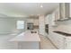 Contemporary kitchen boasting white cabinetry, a large center island, and stainless steel appliances, perfect for entertaining at 4210 Sea Marsh Pl, Parrish, FL 34219