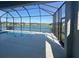 A screened-in pool has views of a serene pond and surrounding neighborhood at 4210 Sea Marsh Pl, Parrish, FL 34219
