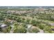Expansive aerial view of a neighborhood with lush greenery, ponds, and well-spaced homes at 4374 Indian Point Trl, Sarasota, FL 34238