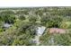 Neighborhood aerial view surrounded by mature trees and landscaping, with a view of the golf course at 4374 Indian Point Trl, Sarasota, FL 34238
