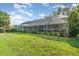 Expansive backyard view showcasing the enclosed pool and lush landscaping at 4374 Indian Point Trl, Sarasota, FL 34238