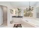 Another view of the bright bathroom with a soaking tub, a glass-enclosed shower, and updated fixtures at 4374 Indian Point Trl, Sarasota, FL 34238