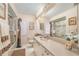 Well-lit bathroom featuring a glass-enclosed shower, long vanity, and decorative giraffe statue at 4374 Indian Point Trl, Sarasota, FL 34238