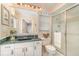 Stylish bathroom with a glass-enclosed shower, marble countertop, and ample storage space at 4374 Indian Point Trl, Sarasota, FL 34238
