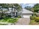 Charming home features a tile roof, manicured lawn and a brick paver walkway to the front door at 4374 Indian Point Trl, Sarasota, FL 34238