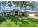 Beautiful home showcasing a manicured lawn and meticulously maintained landscaping at 4374 Indian Point Trl, Sarasota, FL 34238