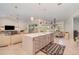 Spacious kitchen featuring an island with eat-in counter, seamlessly flowing into the living area at 4374 Indian Point Trl, Sarasota, FL 34238