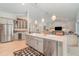 Open concept kitchen boasts stainless steel appliances, island seating, and seamless transition to living area at 4374 Indian Point Trl, Sarasota, FL 34238