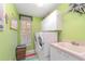 Efficient laundry room with modern washer and dryer, ample storage, and a convenient sink at 4374 Indian Point Trl, Sarasota, FL 34238