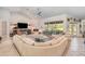 Comfortable living room with plush seating, cozy fireplace, large screen TV, and ample lighting at 4374 Indian Point Trl, Sarasota, FL 34238