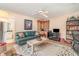 Comfortable living room with neutral tones, a ceiling fan, and a green leather sofa at 4374 Indian Point Trl, Sarasota, FL 34238