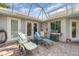 Inviting screened patio with summer kitchen, grill, and tiled flooring at 4374 Indian Point Trl, Sarasota, FL 34238