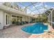 Sparkling screened pool and spa with outdoor seating, perfect for entertaining at 4374 Indian Point Trl, Sarasota, FL 34238