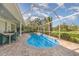 Inviting screened-in pool surrounded by lush landscaping and outdoor seating at 4374 Indian Point Trl, Sarasota, FL 34238