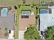 Aerial view of a home with a pool and patio area, surrounded by well-maintained landscaping and neighboring properties at 4637 31St E Ct, Bradenton, FL 34203