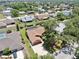 Aerial view of a single-Gathering home featuring a brown roof, attached garage, and a lush backyard at 4637 31St E Ct, Bradenton, FL 34203