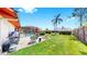 Lush backyard with a pool, fire pit, patio, grill and mature palm trees, perfect for outdoor relaxation and entertainment at 4637 31St E Ct, Bradenton, FL 34203