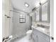 Well-lit bathroom featuring a tiled shower and gray vanity with granite countertop at 4637 31St E Ct, Bradenton, FL 34203