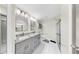 Elegant bathroom with double vanity, tiled floor, and glass-enclosed shower at 4637 31St E Ct, Bradenton, FL 34203