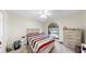 Bright bedroom featuring a striped comforter, neutral walls, and a large window at 4637 31St E Ct, Bradenton, FL 34203