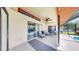 Covered patio featuring tile flooring, fan, and lounge chairs, with a seamless transition to the screened-in pool at 4637 31St E Ct, Bradenton, FL 34203