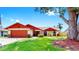 Charming single-story home with a well-manicured lawn, two-car garage, and colorful front-door accent at 4637 31St E Ct, Bradenton, FL 34203