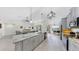 Open kitchen featuring gray cabinets, an island with granite countertops, and stainless steel appliances at 4637 31St E Ct, Bradenton, FL 34203