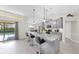 Gray kitchen with island, granite counters, stainless appliances and seating for entertaining at 4637 31St E Ct, Bradenton, FL 34203
