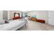 Relaxing bedroom with plush carpet, dresser, flatscreen TV, and sliding glass doors to pool area at 4637 31St E Ct, Bradenton, FL 34203