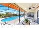 Relaxing screened-in pool area with comfortable lounge seating and a ceiling fan for added comfort at 4637 31St E Ct, Bradenton, FL 34203