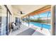 Inviting screened-in patio with tiled flooring, lounge chairs, and seamless access to the backyard and pool at 4637 31St E Ct, Bradenton, FL 34203