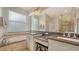 Bathroom featuring a soaking tub, double sinks, granite countertops, and a glass enclosed shower at 5044 Creekside Trl, Sarasota, FL 34243