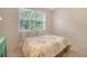 Bedroom featuring a large sunny window with decorative floral bedspread at 5044 Creekside Trl, Sarasota, FL 34243
