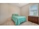 Cozy bedroom with leaf-themed comforter and carpeted floor at 5044 Creekside Trl, Sarasota, FL 34243