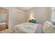 Bedroom with a large sunny window, a closet, and a decorative side table with drawers at 5044 Creekside Trl, Sarasota, FL 34243