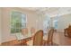 Bright dining area with high ceilings, large windows, and a stylish glass-top table with seating at 5044 Creekside Trl, Sarasota, FL 34243