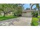 Well-maintained house boasts a two-car garage and an extended driveway for ample parking space at 5044 Creekside Trl, Sarasota, FL 34243