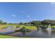 Scenic golf course view with a wooden bridge over water and lush landscaping, perfect for outdoor enjoyment at 5044 Creekside Trl, Sarasota, FL 34243