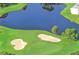 Aerial view of the golf course, showing sand traps, water features, and beautifully manicured greens at 5044 Creekside Trl, Sarasota, FL 34243