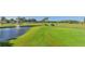 Expansive golf course with a water feature, palm trees, and manicured greens, ideal for leisure at 5044 Creekside Trl, Sarasota, FL 34243