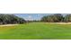 Well-maintained golf course fairway with sand traps and mature trees, providing a challenging yet beautiful setting at 5044 Creekside Trl, Sarasota, FL 34243