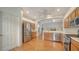 Open-concept kitchen with stainless steel appliances, wood cabinetry, and bright lighting at 5044 Creekside Trl, Sarasota, FL 34243