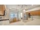 Well-lit kitchen with stainless steel appliances, breakfast bar, and adjacent laundry room at 5044 Creekside Trl, Sarasota, FL 34243