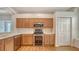 Modern kitchen features stainless steel appliances, light wood cabinets, and light countertops at 5044 Creekside Trl, Sarasota, FL 34243