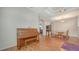 Spacious area with wood floors, piano, open archways, and decorative furniture at 5044 Creekside Trl, Sarasota, FL 34243
