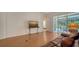Cozy living room with hardwood floors and direct access to an outdoor patio via sliding glass doors at 5044 Creekside Trl, Sarasota, FL 34243