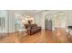 Comfortable living room featuring hardwood floors, a leather sofa, and seamless transition to kitchen at 5044 Creekside Trl, Sarasota, FL 34243