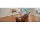 Relaxing living area with hardwood floors, and sliding door access to the patio and beautiful views at 5044 Creekside Trl, Sarasota, FL 34243