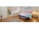 This is a bright main bedroom offering wood floors, large windows, and an ensuite bathroom at 5044 Creekside Trl, Sarasota, FL 34243